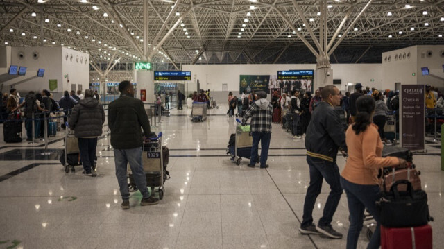 Passengers walk and queue inside the Addis Ababa international airport on February 5, 2024.