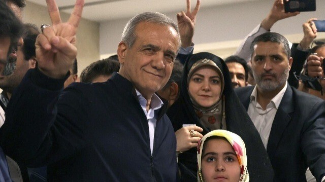 Le candidat à la présidence iranienne, le réformateur Massoud Pezeshkian, brandit le signe V de la victoire après avoir voté lors de l'élection présidentielle à Téhéran, le 28 juin 2024. 