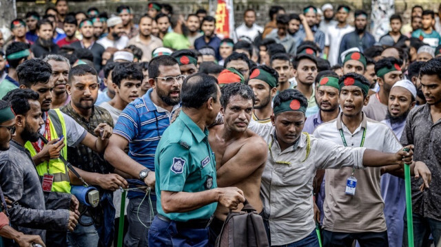 Des manifestants entourent un sympathisant présumé de l'ex-premier ministre Sheikh Hasina, près de la maison de son père Sheikh Mujibur Rahman, "Bangabandhu", le premier président du Bangladesh indépendant, à Dhaka, le 15 août 2024, à l'occasion de l'anniversaire de son assassinat.