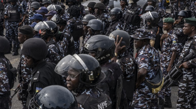 Des policiers se tiennent près du bureau du gouverneur de l'État de Lagos alors que des manifestants défilent lors d'une veillée de deuil à Ikeja, Lagos, le 9 août 2024.