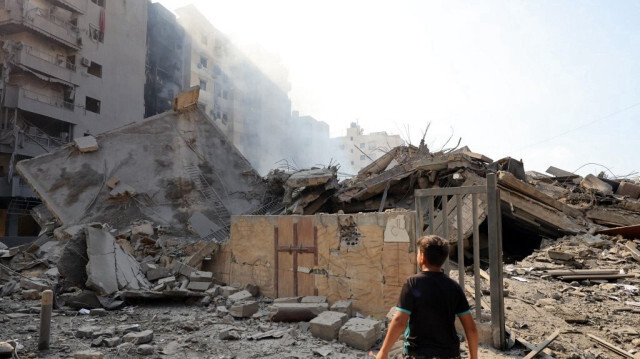 Un jeune garçon se tient devant un bâtiment détruit à la suite des frappes aériennes israéliennes de la nuit sur le quartier de Mreijeh, dans la banlieue sud de Beyrouth, le 28 septembre 2024.