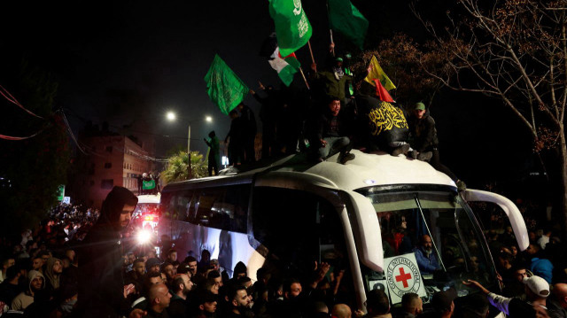 People gather around a bus carrying freed Palestinian prisoners after their release outside of Ofer prison in the occupied West Bank early Monday. 