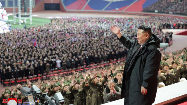 Le dirigeant nord-coréen Kim Jong Un faisant un signe de la main alors qu'il assiste à un spectacle pour célébrer le Nouvel An au stade du 1er mai à Pyongyang.