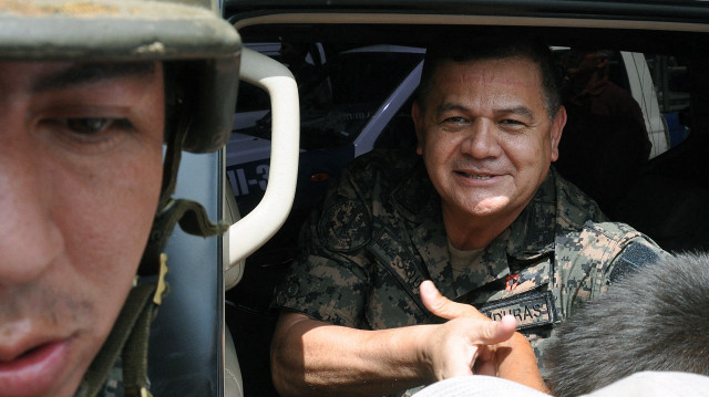 L'ex-général Romeo Vasquez, saluant un sympathisant alors qu'il quitte une manifestation contre le président déchu de l'époque, Manuel Zelaya, sur la place Morazan, dans le centre de Tegucigalpa, le 30 juin 2009.