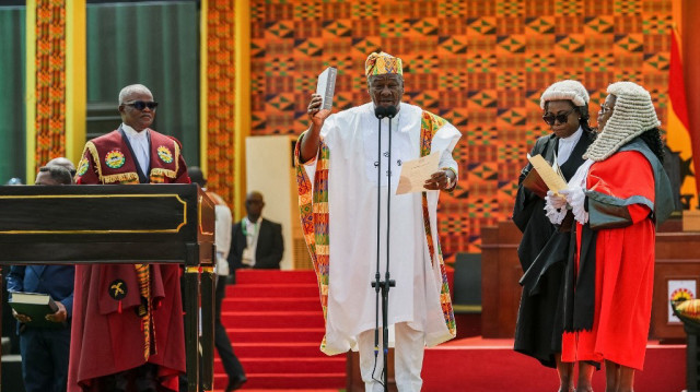 Le nouveau président du Ghana, John Mahama (C), tient une bible alors qu'il prête serment lors de son investiture sur la place de l'Indépendance à Accra, le 7 janvier 2025.