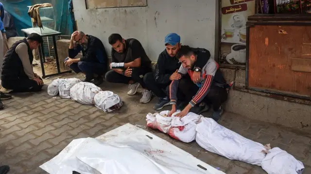 Des proches pleurent les corps d'enfants tués lors d'une frappe israélienne, à Nuseirat, dans le centre de la bande de Gaza, le 29 octobre 2025. 