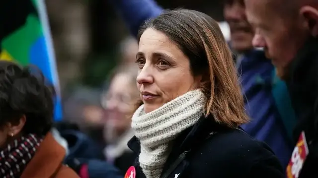 La secrétaire générale de la Confédération générale du travail (CGT), Sophie Binet, observe une manifestation organisée dans le cadre d'un appel lancé par les syndicats à la grève et à la manifestation pour réclamer des augmentations salariales et dénoncer l'austérité, à Paris, le 2 décembre 2025. 