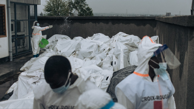 Des membres de la Croix-Rouge congolaise se tiennent au milieu de corps dans des sacs mortuaires à la morgue de l'hôpital général de Goma, le 1er février 2025. Le groupe M23, soutenu par le Rwanda, progresse vers le sud dans l'est de la République démocratique du Congo, riche en minerais, alors que les Nations unies annoncent que l'escalade du conflit a fait au moins 700 morts en moins d'une semaine. Le M23 s'est emparé de Goma, centre commercial vital de l'est, après d'intenses combats cette semaine, et a promis de marcher jusqu'à la capitale de la République démocratique du Congo.