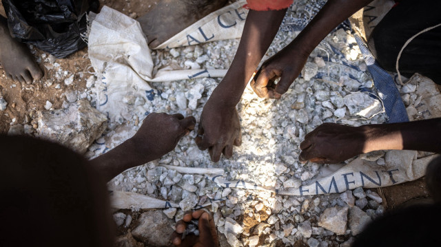 Des enfants manipulent des pierres contenant du lithium dans un entrepôt à Nasarawa, dans l'État de Nasarawa, le 23 janvier 2025.