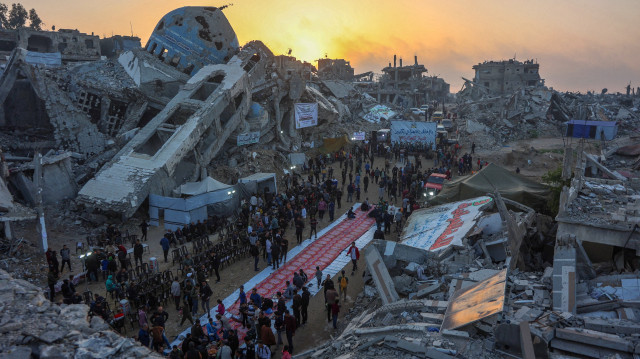 Des Palestiniens se rassemblent pour un repas de rupture du jeûne devant la mosquée détruite de Salim Abu Muslim à Beit Lahia, dans le nord de la bande de Gaza, le 15 mars 2025, pendant le mois de jeûne musulman du Ramadan. L'agence de défense civile de Gaza a déclaré que neuf personnes, dont des journalistes, ont été tuées dans des frappes israéliennes le 15 mars, des attaques qui pourraient mettre en péril la fragile trêve dans le territoire palestinien.