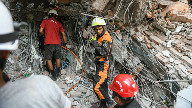 Des sauveteurs fouillent les décombres d'un bâtiment endommagé à la recherche de survivants à Mandalay, le 29 mars 2025, au lendemain d'un tremblement de terre qui a frappé le centre du Myanmar. Le 29 mars, des sauveteurs ont fouillé dans les décombres de bâtiments effondrés, à la recherche désespérée de survivants, après le violent tremblement de terre qui a frappé le Myanmar et la Thaïlande, faisant plus de 1 000 morts.