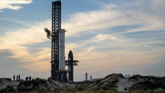 Des personnes observent le vaisseau spatial SpaceX Flight 8 alors qu'il est stationné près de la rampe de lancement Orbital A avant son lancement sur la plage de Boca Chica, le 3 mars 2025 à Boca Chica Beach, au Texas.