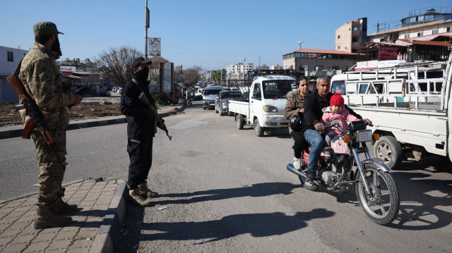Des membres des forces de sécurité du nouveau gouvernement syrien tiennent un poste de contrôle à l'entrée de la ville syrienne de Jableh, dans la province côtière de Lattaquié, le 28 janvier 2025.