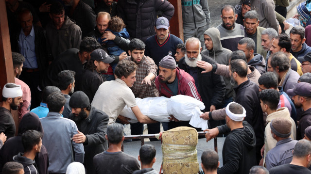 Des Palestiniens transportent le corps d'une personne tuée lors d'une frappe israélienne sur un bâtiment du quartier de Shujaiya, dans la cour de l'hôpital arabe Al-Ahli, dans le nord de la bande de Gaza, le 10 avril 2025. Dans une mise à jour du 10 avril, le ministère de la santé du territoire dirigé par le Hamas a déclaré qu'au moins 1 522 Palestiniens avaient été tués lors de la nouvelle offensive israélienne, ce qui porte à 50 886 le nombre total de morts depuis le début de la guerre.
