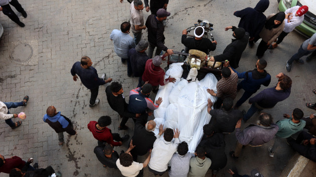 Des Palestiniens transportent les corps des personnes tuées lors d'une frappe israélienne sur un bâtiment du quartier de Shujaiya, dans la cour de l'hôpital arabe Al-Ahli, dans le nord de la bande de Gaza, le 10 avril 2025. Le 10 avril, le ministère de la santé du territoire dirigé par le Hamas a déclaré qu'au moins 1 522 Palestiniens avaient été tués lors de la nouvelle offensive israélienne, ce qui porte à 50 886 le nombre total de morts depuis le début de la guerre.