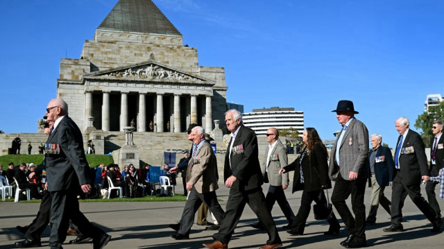 D'anciens militaires défilent devant le Shrine of Remembrance lors d'une marche d'anciens et d'actuels membres du personnel de la Défense à l'occasion de la journée ANZAC (Australian and New Zealand Army Corps), pour honorer les soldats morts dans l'exercice de leurs fonctions, à Melbourne.