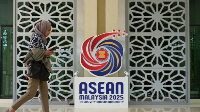Une femme passe devant le logo de l'Asean sur l'île de Langkawi, station balnéaire de Malaisie, le 17 janvier 2025.