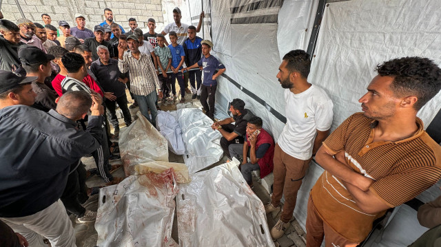 Des Palestiniens se recueillent devant les corps de proches tués lors de frappes israéliennes sur des tentes de déplacés dans la zone ouest de Mawasi, à l'hôpital Nasser de Khan Yunis, dans le sud de la bande de Gaza, le 18 mai 2025. Le porte-parole de la défense civile, Mahmud Bassal, a déclaré à l'AFP que 22 personnes avaient été tuées et au moins 100 autres blessées lors d'une attaque menée avant l'aube contre des tentes abritant des Palestiniens déplacés à Al-Mawasi, dans le sud de la bande de Gaza.