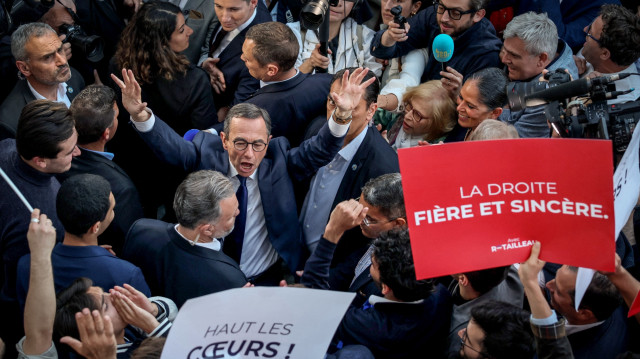 Le ministre français de l'Intérieur, Bruno Retailleau (C), se réjouit avec ses partisans, entouré de journalistes, alors qu'il quitte le siège du parti de droite français Les Républicains (LR) après son élection à la présidence de LR, à Paris, le 18 mai 2025.