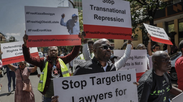 Un manifestant tient une pancarte alors que des groupes de défense des droits de l'homme organisent une manifestation pour la libération du leader de l'opposition ougandaise Kizza Besigye, à Nairobi, le 24 février 2025.