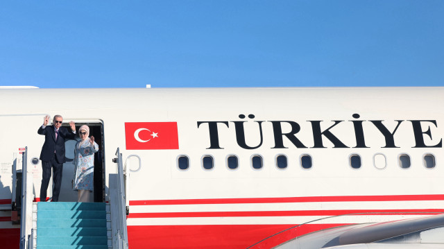 Turkish President Recep Tayyip Erdogan (L) and his wife Emine Erdogan (R) wave hands those who came to see them off before their departure for Hungary to attend the signing and award ceremonies of the Informal Summit of the Organization of Turkic States at the Esenboga Airport in Ankara, Turkiye on May 21, 2025. (AA)