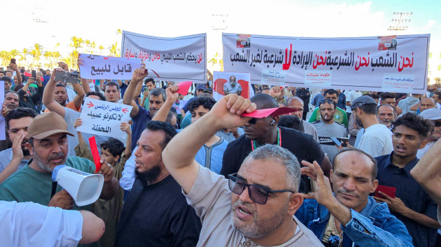 Des manifestants brandissent des cartons rouges alors qu'ils se rassemblent pour une manifestation anti-gouvernementale, appelant le gouvernement d'unité nationale (GNU) dirigé par Abdulhamid Dbeibah à démissionner, sur la place des Martyrs à Tripoli, capitale de la Libye, le 30 mai 2025.