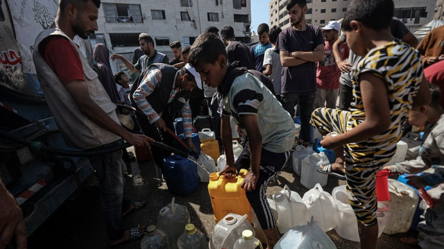 An aid truck arrives in the camp and distributes water to displaced Palestinians, on June 19, 2025 in Gaza City, Gaza.