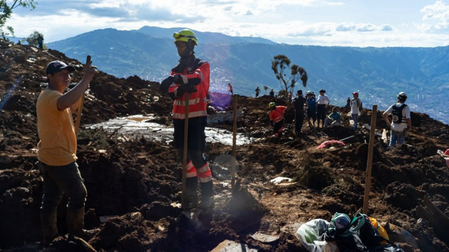 Rescue workers search through the rubble after a deadly landslide struck the Granizal sector, on the border between Medellín and Bello, Colombia on June 25, 2025.