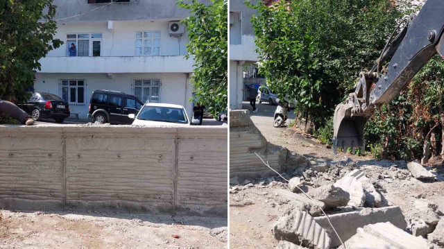 Belediyeye ait iş makinesiyle beton duvar yıkılarak, yol yeniden araç ve yaya trafiğine açıldı.