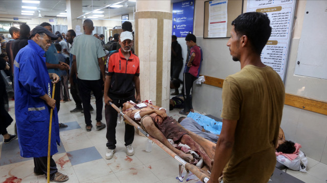 Un Palestinien blessé lors d'une distribution de nourriture dans le quartier Al-Tina de Khan Yunis, dans le sud de la bande de Gaza, est transporté sur une civière à l'hôpital Nasser, le 19 juillet 2025. Le 19 juillet, l'agence de défense civile de Gaza a déclaré que les attaques israéliennes avaient tué 25 personnes et blessé plus de 100 autres près de deux centres d'aide dans le sud du territoire palestinien.