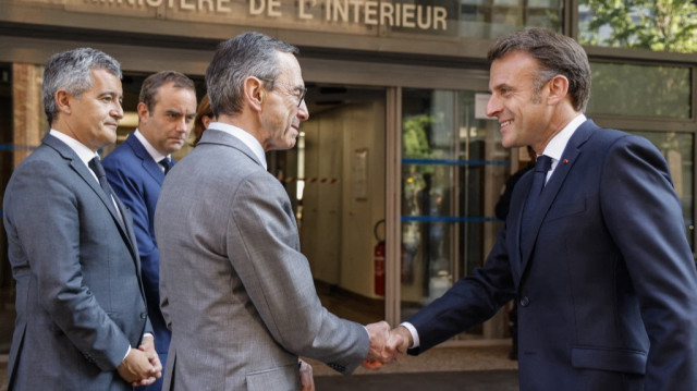 Le président français Emmanuel Macron (à droite) serre la main du ministre français de l'Intérieur Bruno Retailleau (au centre) à leur arrivée avec le ministre français de la Justice Gérald Darmanin (à gauche) et le ministre français des Armées Sébastien Lecornu pour une visite du quartier général interministériel de lutte contre la criminalité organisée (EMCO - État-major interministériel de lutte contre la criminalité organisée), à Nanterre, en banlieue parisienne, le 14 mai 2025.