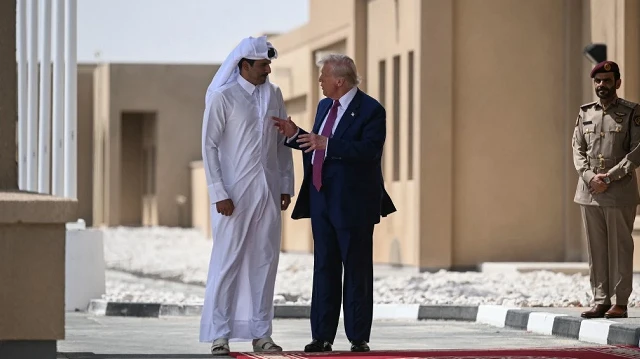 L'émir du Qatar, Cheikh Tamim bin Hamad al-Thani (à gauche), s'entretient avec le président américain Donald Trump à la fin de l'étape qatarienne de sa tournée régionale, à la base aérienne d'Al-Udeid, au sud-ouest de Doha, le 15 mai 2025.