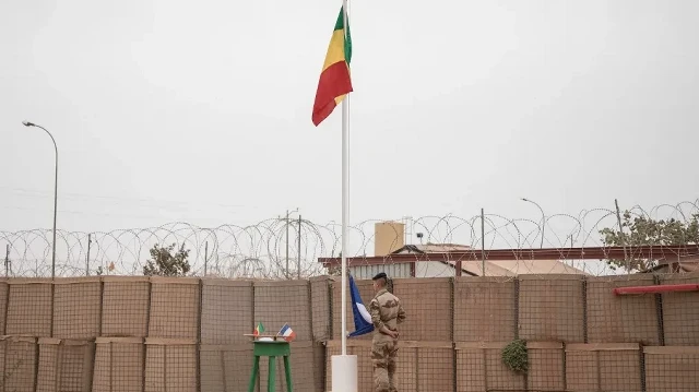 Le drapeau malien est hissé lors de la cérémonie de transfert de la base militaire Barkhane de l'armée française à l'armée malienne à Tombouctou, le 14 décembre 2021.