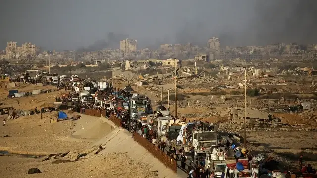 Des Palestiniens déplacés transportent leurs affaires en se dirigeant vers le sud sur une route du camp de réfugiés de Nuseirat, dans le centre de la bande de Gaza, le 23 septembre 2025.