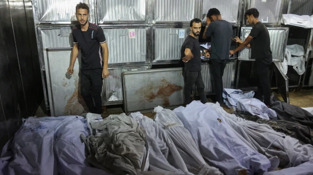 Des Palestiniens pleurent devant les corps recouverts d'un linceul de leurs proches tués lors des frappes israéliennes sur la ville de Gaza à l'aube, à la morgue de l'hôpital Al-Shifa, le 2 septembre 2025. L'agence de défense civile de Gaza a déclaré le 2 septembre que les frappes israéliennes sur un appartement et un immeuble résidentiel avaient tué 13 personnes pendant la nuit.