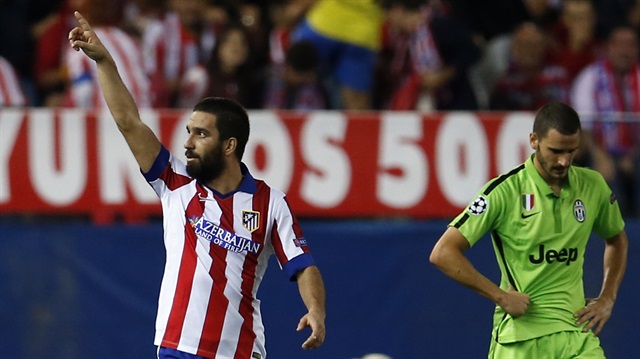 Atletico Madrid's Arda Turan (L) celebrates after scoring a goal, next to Juventus' Leonardo Bonucci during their Champions League soccer match at Vicente Calderon stadium in Madrid.