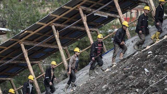 Rescue efforts continue at coal mine where 18 miners were trapped following the flash flood inside as their co-workers desperately waits for good news 