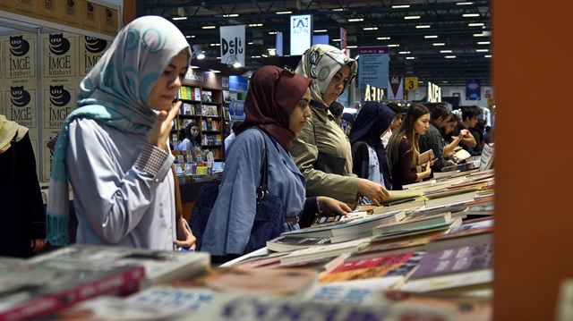  Visitors look at the books at the 33rd Istanbul International Book Fair at the TUYAP Fair and Convention Center in Istanbul, Turkey on November 8, 2014.