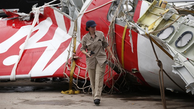 An Airbus investigator walks near part of the tail of the AirAsia QZ8501 passenger plane in Kumai Port, near Pangkalan Bun, Central Kalimantan January 12, 2015. Flight QZ8501 vanished from radar screens over the northern Java Sea on December 28, 2014 less than half-way into a two-hour flight from Indonesia's second-biggest city of Surabaya to Singapore.   REUTERS/Darren Whiteside   (INDONESIA - Tags: DISASTER TRANSPORT TPX IMAGES OF THE DAY)