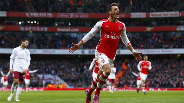 Arsenal's Mesut Ozil celebrates his goal against Aston Villa during their English Premier League soccer match at the Emirates Stadium in London, February 1, 2015.   