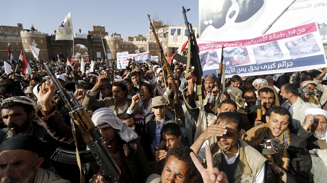 Followers of the Houthi demonstrate against the Saudi-led air strikes on Yemen, in Sanaa April 1, 2015. The banner reads, "You committ major crimes against the Yemenis to please the Americans and Israelis." REUTERS/Khaled Abdullah