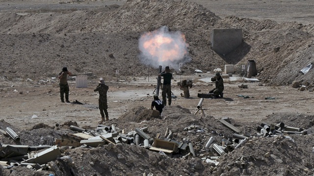 Members of the Iraqi army and Shi'ite fighters launch a mortar toward Islamic State militants outskirt the city of Falluja, Iraq May 19, 2015. Iraqi security forces on Tuesday deployed tanks and artillery around Ramadi to confront Islamic State fighters who have captured the city in a major defeat for the Baghdad government and its Western backers.  REUTERS/Stringer
