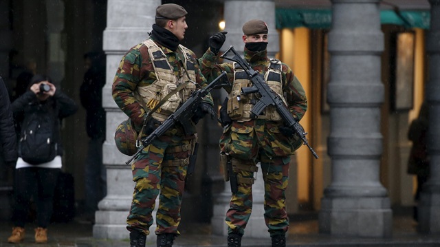 Belgian soldiers patrol Brussels' Grand Place during a continued high level of security following the recent deadly Paris attacks