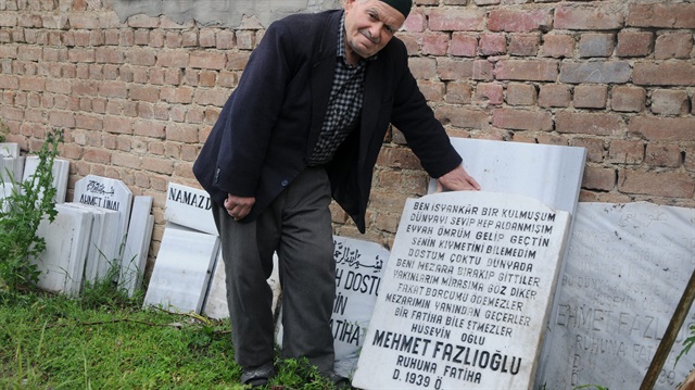 Evlatlarının başta tepki gösterdiğini söyleyen Fazlıoğlu, mezar taşının başında poz verdi.