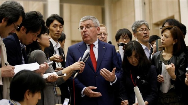 President of the International Olympic Committee Thomas Bach (C) talks to reporters after meeting Tokyo governor Yuriko Koike at Tokyo Metropolitan Government Building in Tokyo, Japan, October 18, 2016.