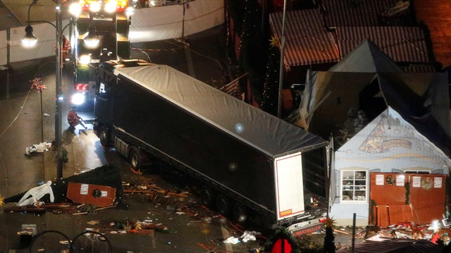A tow truck operates at the scene where a truck that ploughed through a crowd at a Berlin Christmas market
