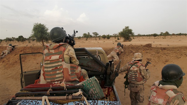 Niger soldiers guard with their weapons pointed towards the border with neighbouring Nigeria