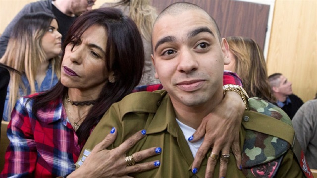 Israeli soldier Elor Azaria is embraced by his mother at the start of is sentencing hearing at a military court in Tel Aviv, Israel February 21, 2017.