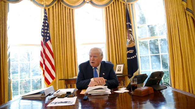 U.S. President Donald Trump gives an interview from his desk in the Oval Office.