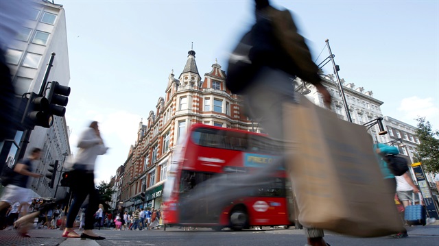 Shoppers cross the road in Oxford Street, in London, Britain